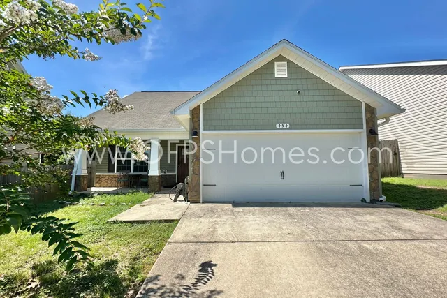 a view of a patio with table and chairs with wooden floor and plants