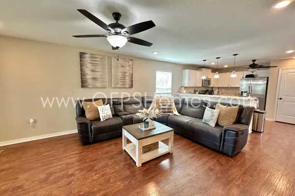 a living room with furniture and wooden floor