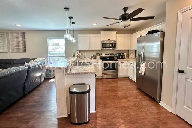 a kitchen with a sink stove and microwave
