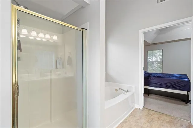 a bathroom with a tub shower and sink