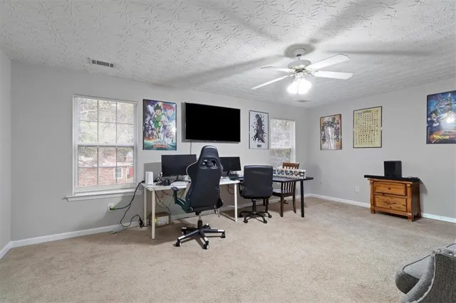 a view of a livingroom with workspace and a window