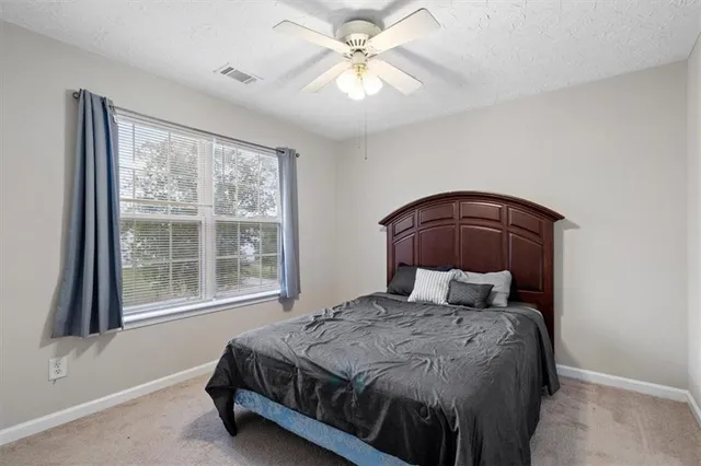 a bedroom with a bed and window