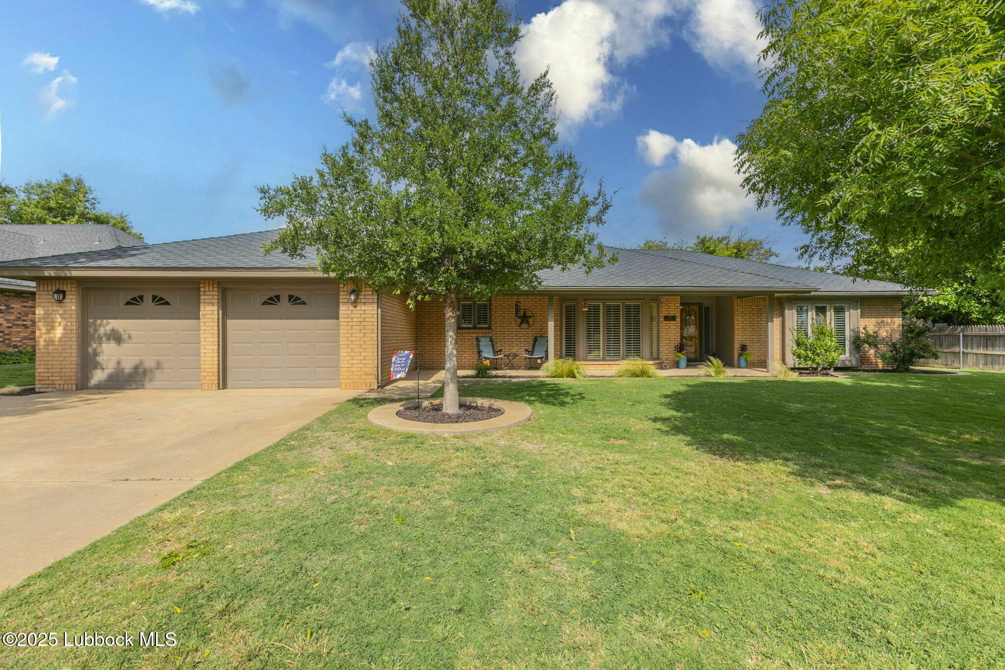 a front view of a house with yard and green space