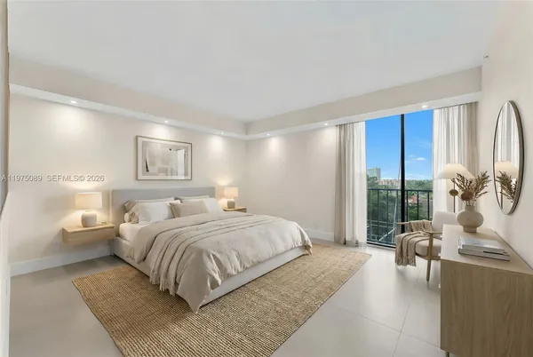 a bedroom with a large bed and a large window