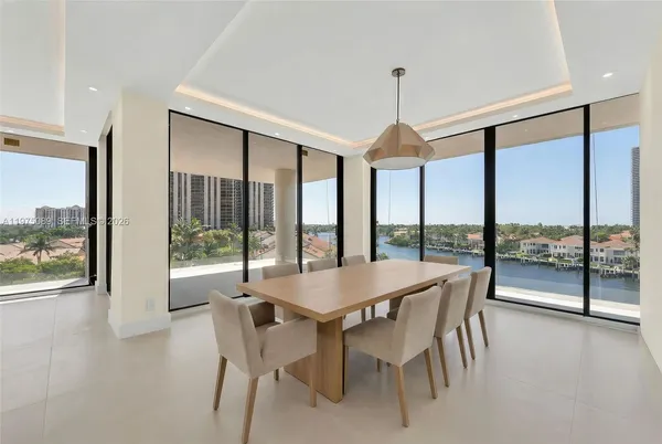 a dining room with furniture window and wooden floor