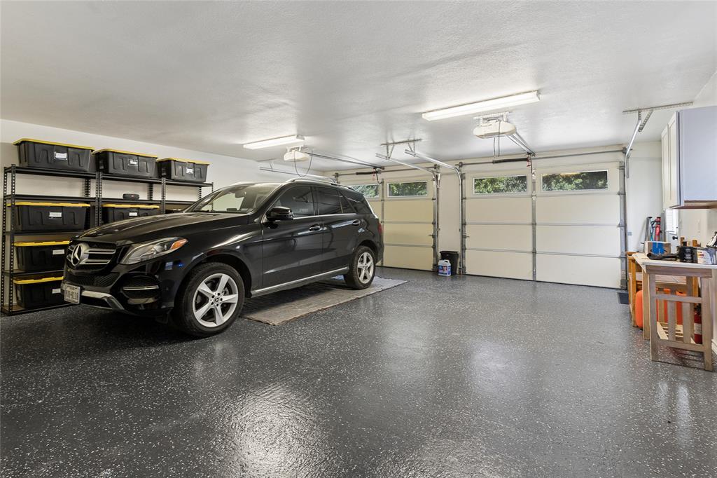4030 Weston Road McKinney, TX 75071 - Photo 29 of 39 Oversized garage with epoxy floors. Above garage is workshop.