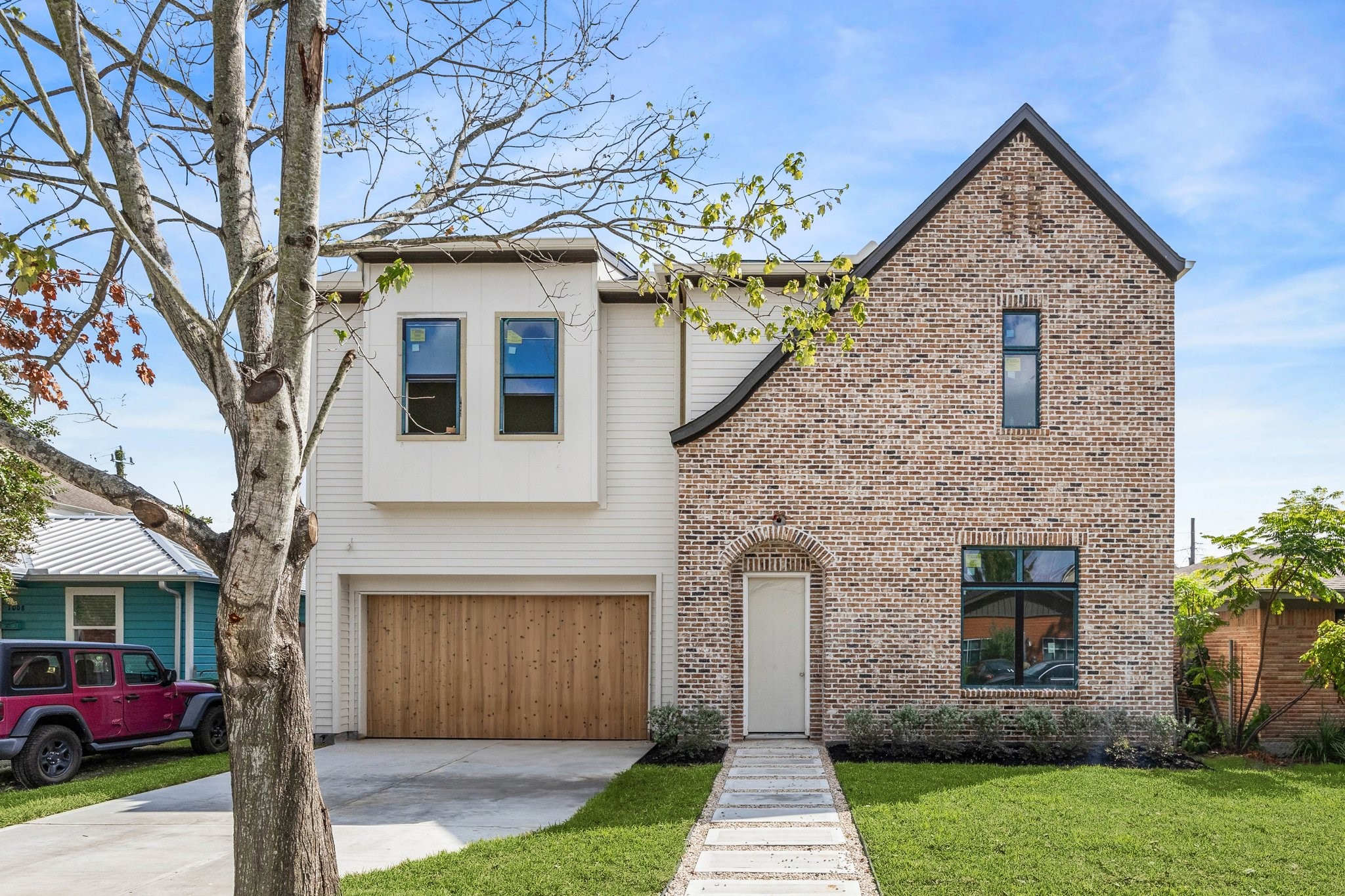 1002 East 25th Street Houston, TX 77009 - Photo 1 of 45 This Sunset Heights home blends classic proportions with modern elements, featuring brick and siding.