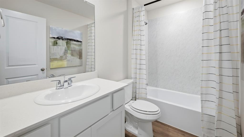1957 Freeman Street Tyler, TX 75704 - Photo 24 of 25 Bathroom featuring a single vanity with an integrated sink, polished chrome faucet, and expansive wall mirror