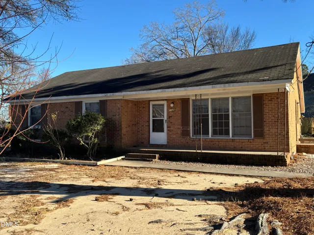 a backyard of a house with yard and outdoor seating