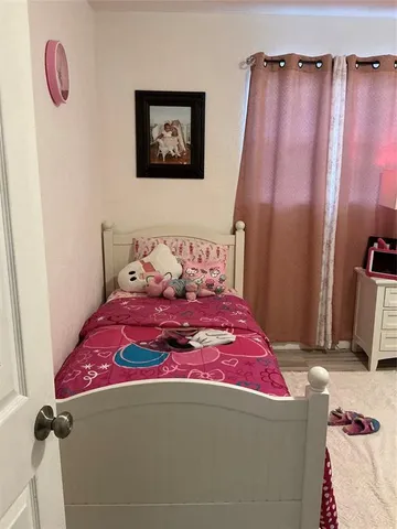 a bedroom with a bed and a mirror