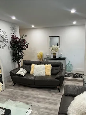 a living room with furniture and a potted plant
