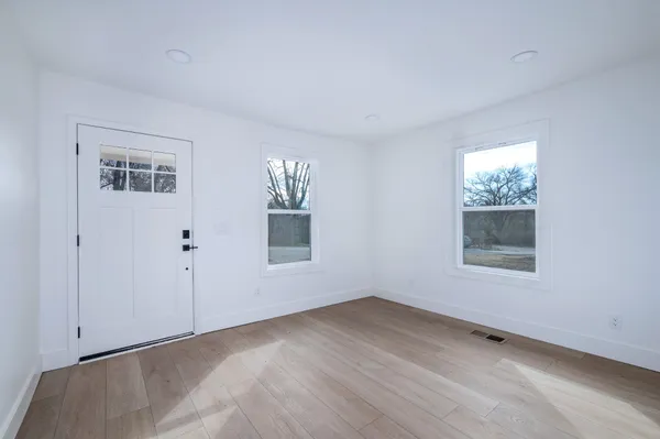 wooden floor in an empty room with a window