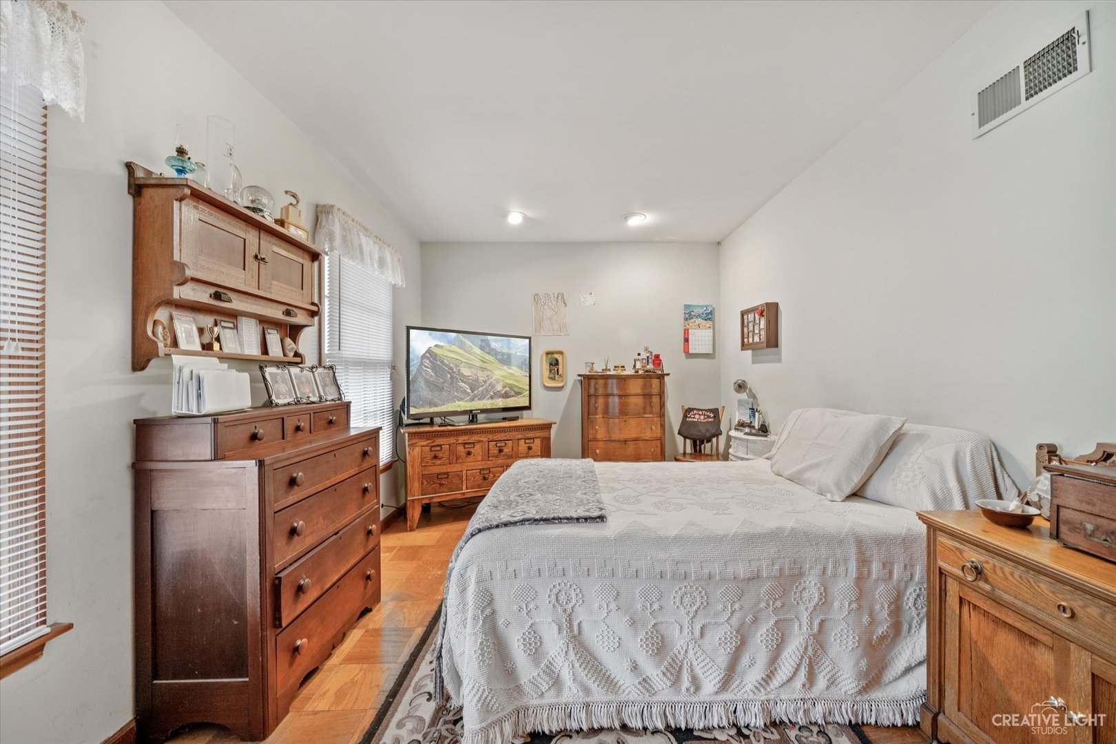 1268 North Randall Road Aurora, IL 60506 - Photo 13 of 28 a bedroom with a bed and wooden floor