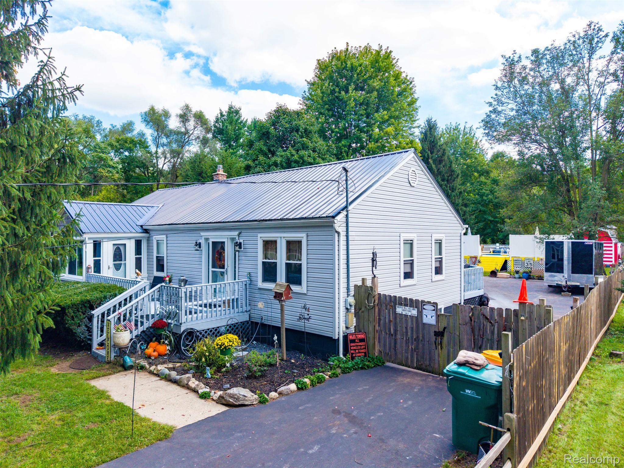 36739 Wick Road Romulus, MI 48174 - Photo 36 of 56 Light-toned siding exterior with a metal roof