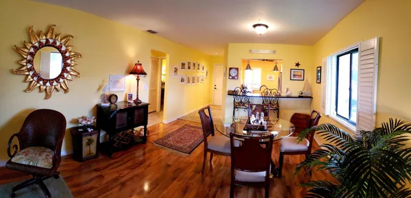a view of a dining room with furniture and wooden floor