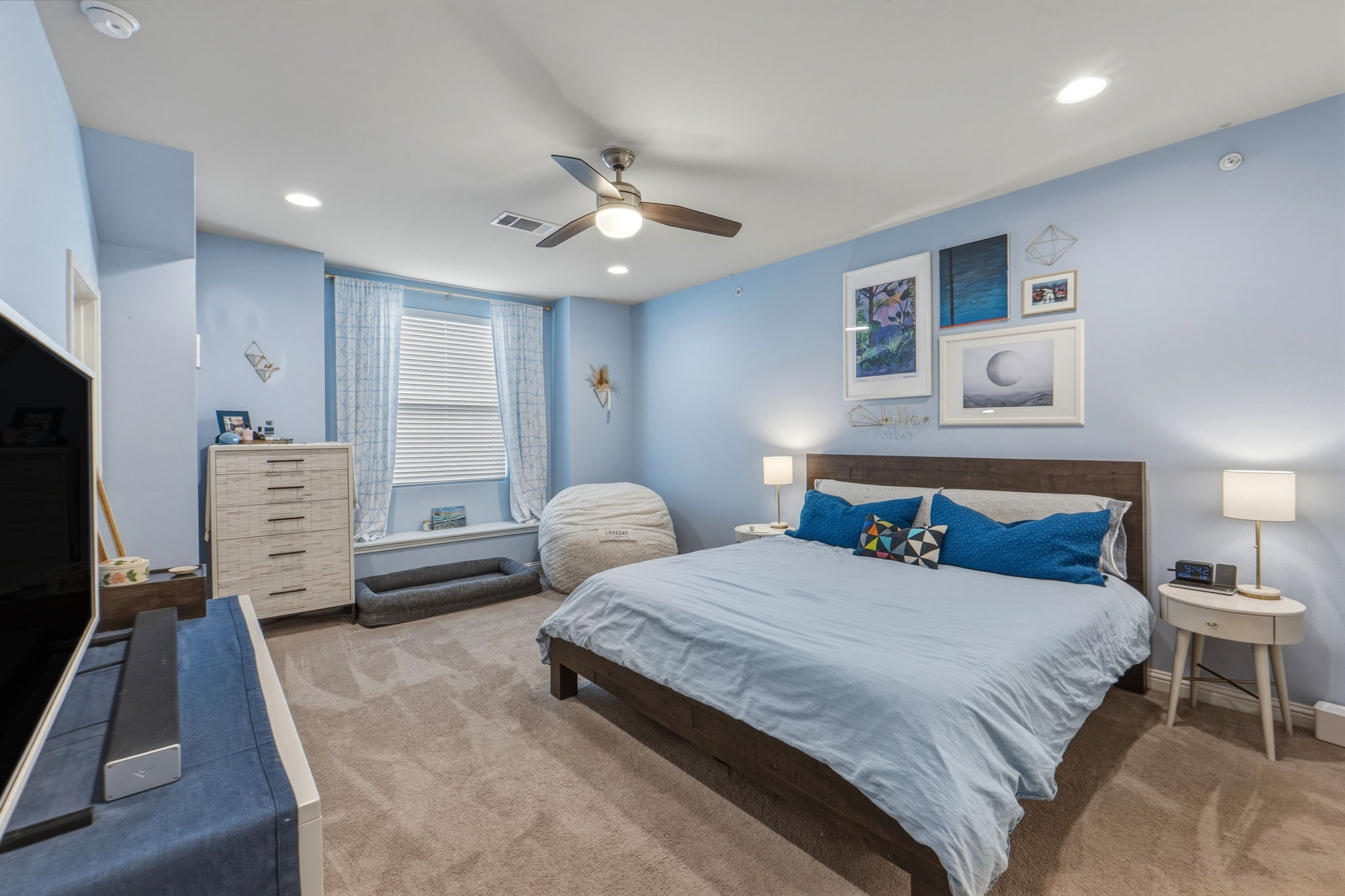 6814 East Riverside Drive, Unit 34 Austin, TX 78741 - Photo 16 of 26 a bedroom with a bed and a flat screen tv