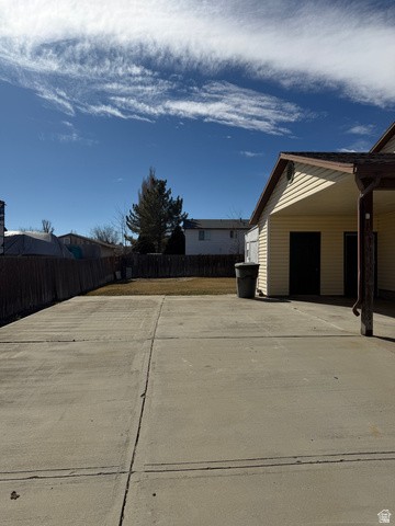 1259 West Raintree Drive Price, UT 84501 - Photo 7 of 10 Fenced backyard with concrete driveway