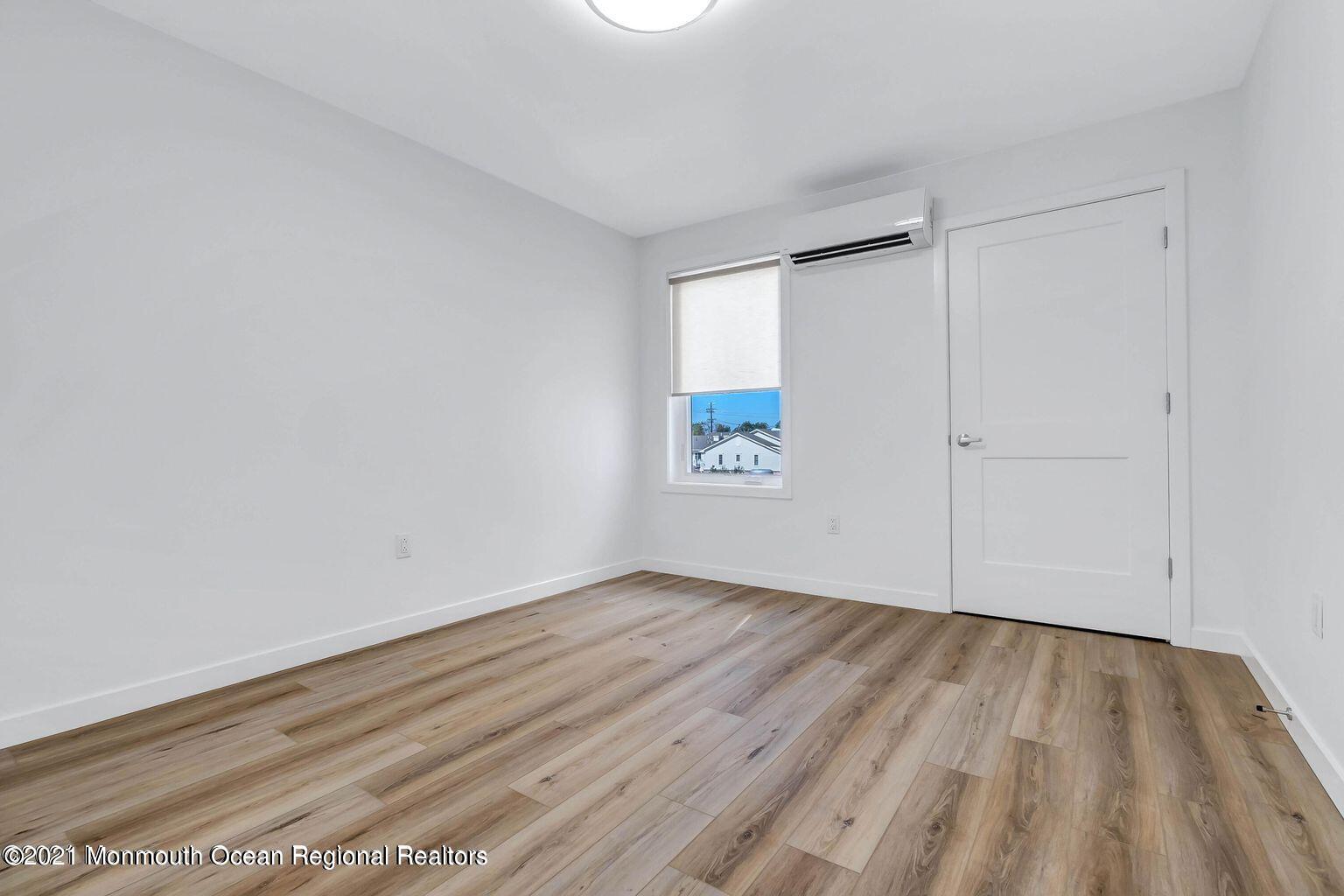 131 Brighton Avenue, Unit 301 Long Branch, NJ 07740 - Photo 14 of 31 a view of an empty room with wooden and a window