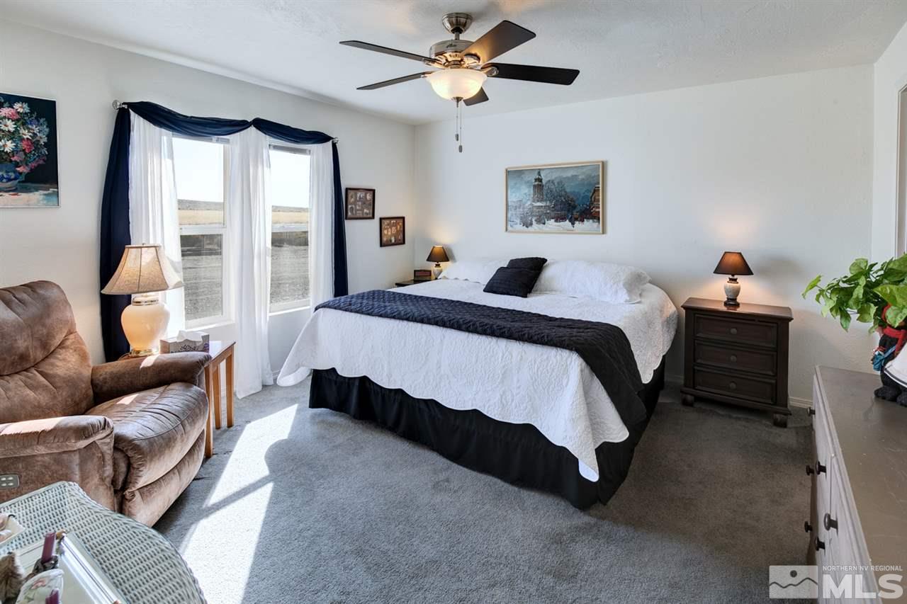 5954 Workman Road Fallon, NV 89406 - Photo 11 of 21 a spacious bedroom with a bed couch and a window