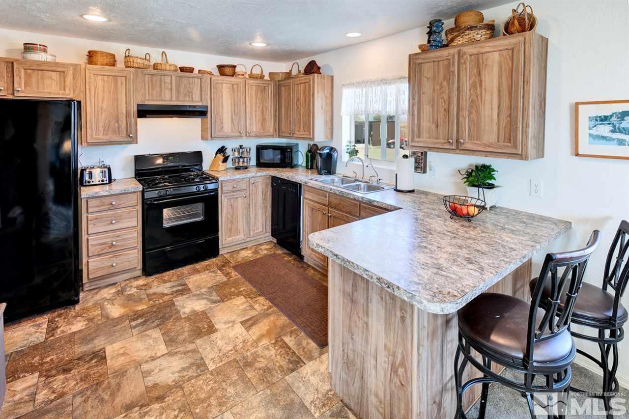 5954 Workman Road Fallon, NV 89406 - Photo 4 of 21 a kitchen with stainless steel appliances a stove a sink dishwasher and a refrigerator