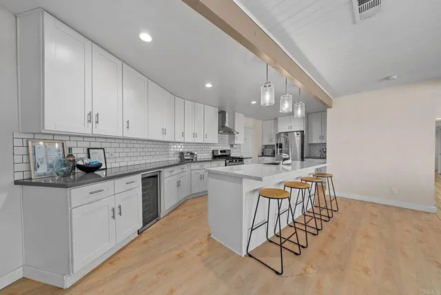 a kitchen with stainless steel appliances granite countertop a sink and cabinets