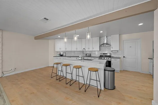 a kitchen with a sink cabinets and wooden floor
