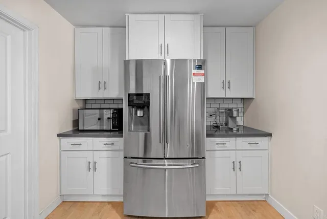 a kitchen with granite countertop stainless steel appliances cabinets a sink and a counter top space