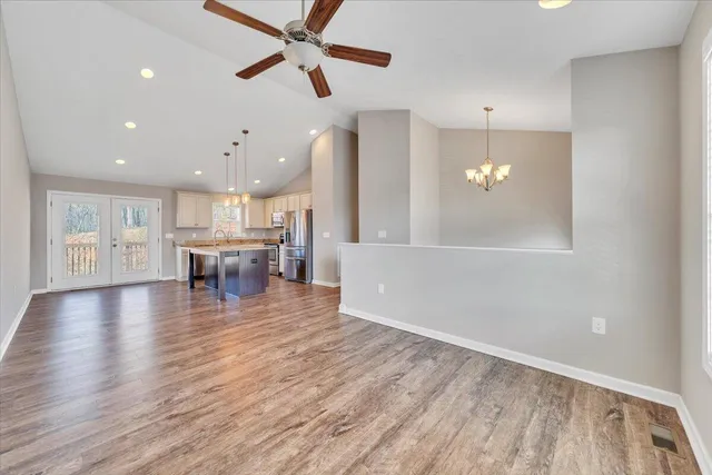 a view of a kitchen and dining room with wooden floor