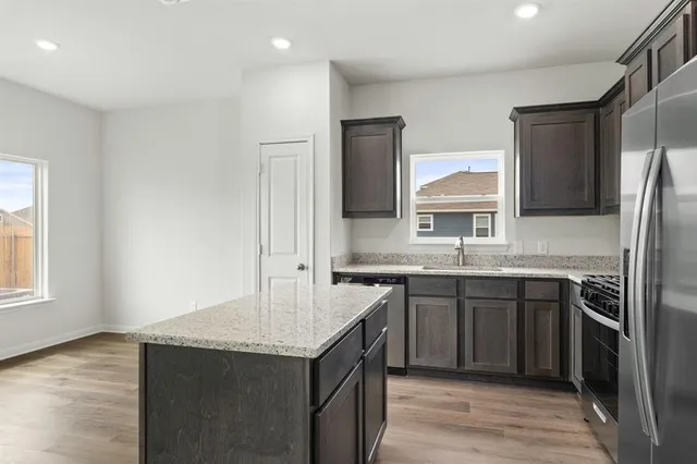 a kitchen with a sink and a refrigerator