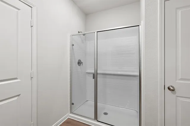 a bathroom with a glass shower door