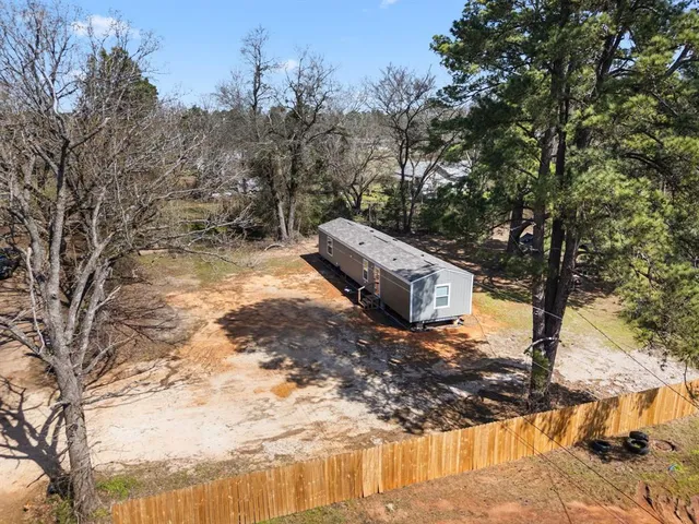 a view of a yard with large trees