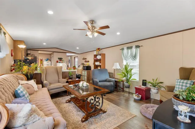 a living room with furniture and a ceiling fan