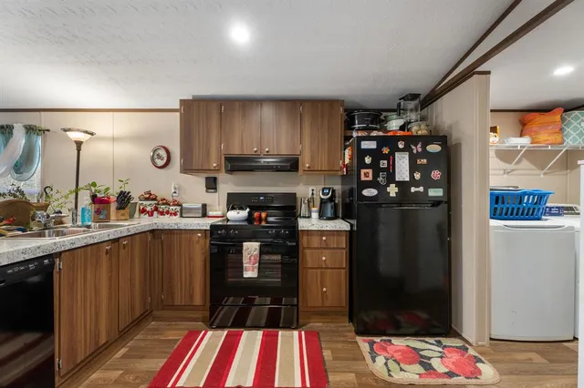 a kitchen with stainless steel appliances a sink and a refrigerator