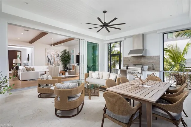 a living room with fireplace furniture and a large window