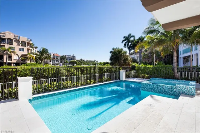 a view of a patio with a table and chairs next to a yard