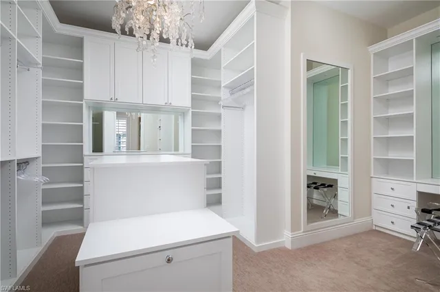 a view of cabinets and utility room with racks