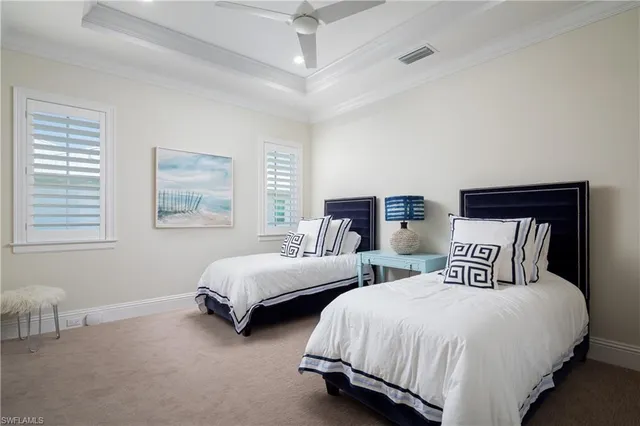 a bedroom with two beds and a night stand