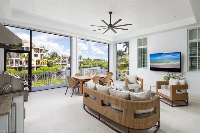 a living room with furniture large window and a flat screen tv