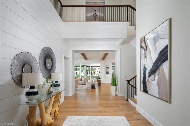 a view of entryway and hall with wooden floor