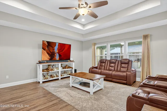 a view of livingroom with hardwood floor and a ceiling fan