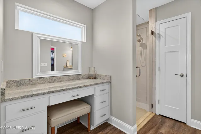 a view of a backyard with couches plants and wooden fence