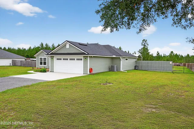 a view of a house with a big yard and potted plants