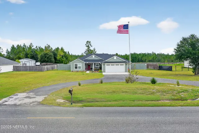 a front view of a house with a yard and porch