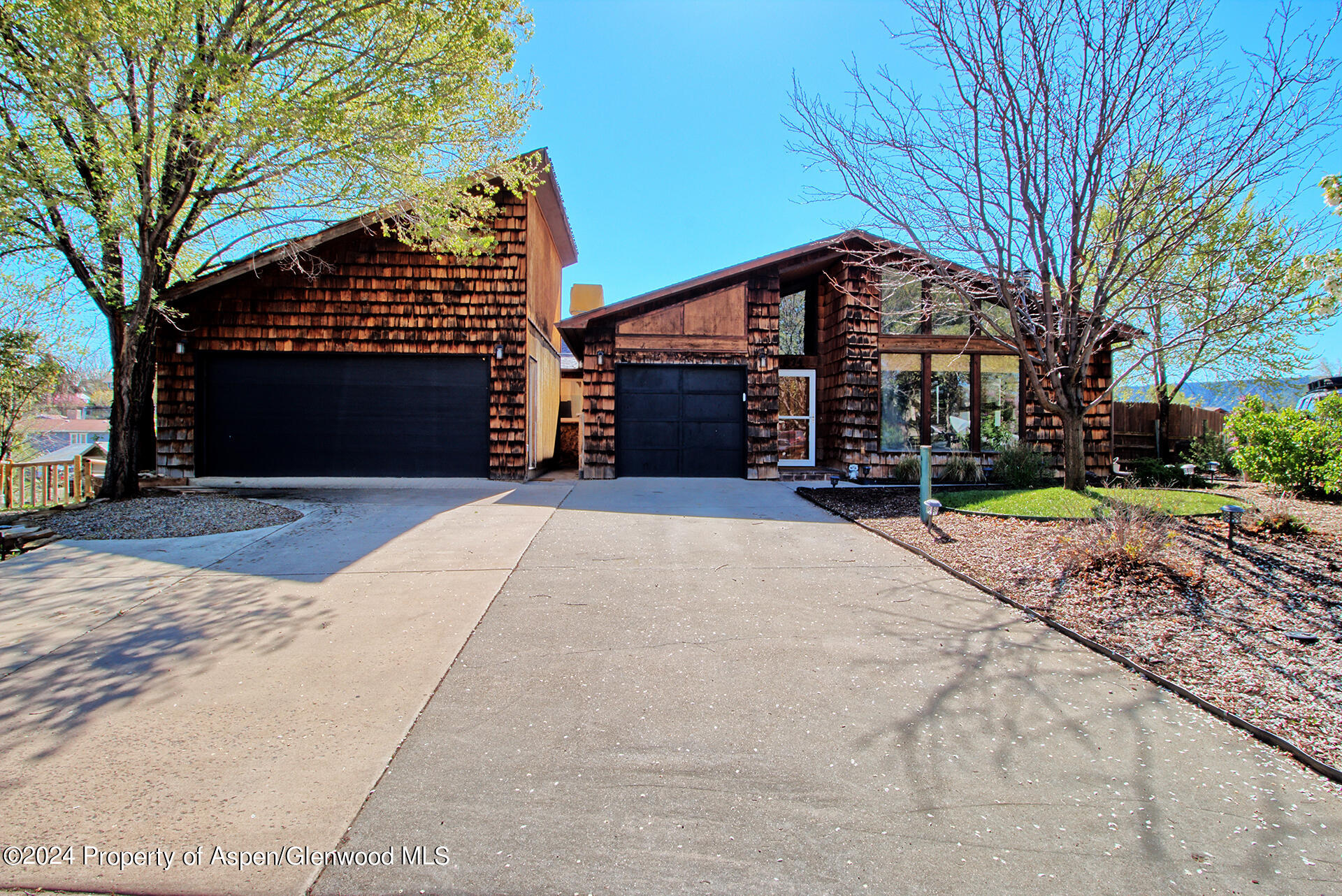 674 Mesa Court Rifle, CO 81650 - Photo 1 of 38 a front view of a house with a yard and garage