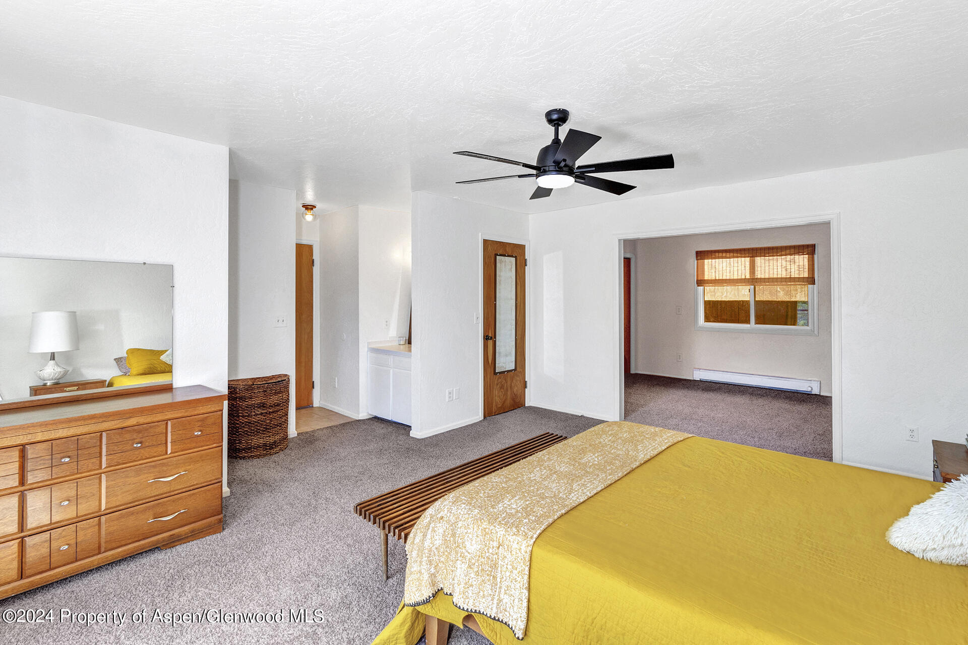 674 Mesa Court Rifle, CO 81650 - Photo 16 of 38 a bedroom with a bed and a chandelier
