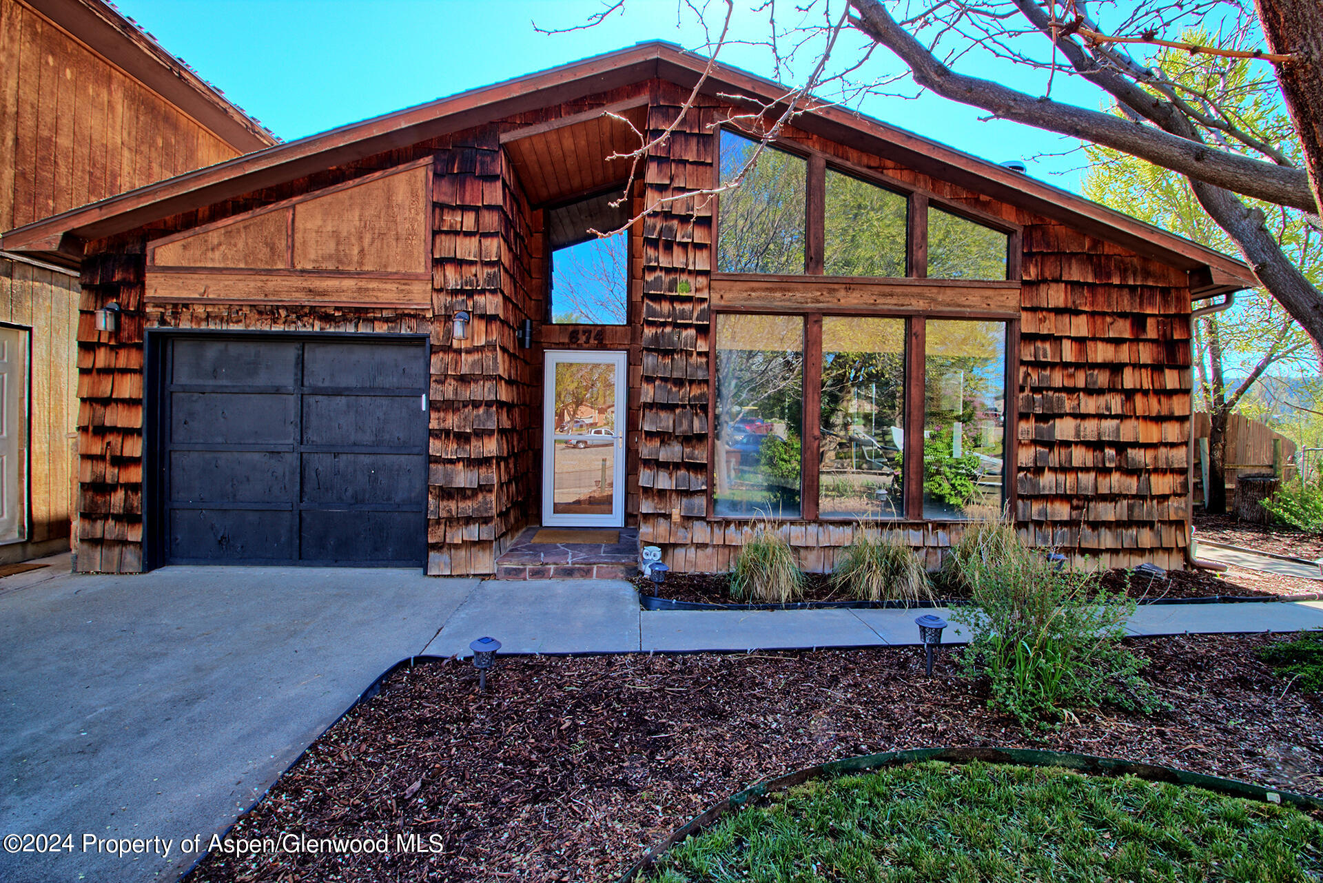 674 Mesa Court Rifle, CO 81650 - Photo 2 of 38 a view of a house with a small yard and plants