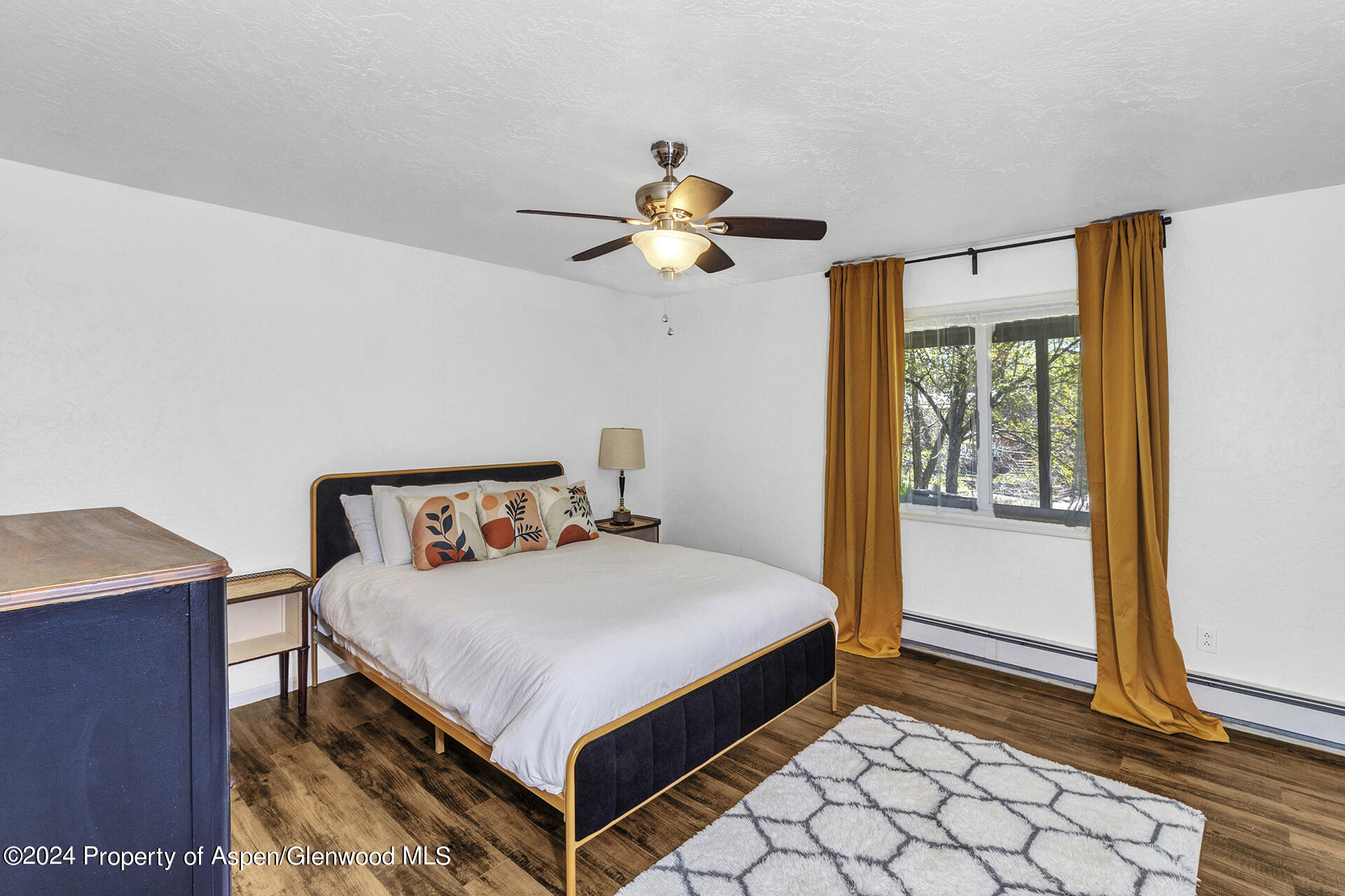674 Mesa Court Rifle, CO 81650 - Photo 23 of 38 a bedroom with a bed and a chandelier