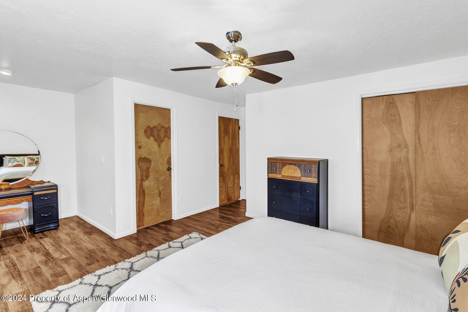 674 Mesa Court Rifle, CO 81650 - Photo 24 of 38 a bedroom with a bed and a chandelier