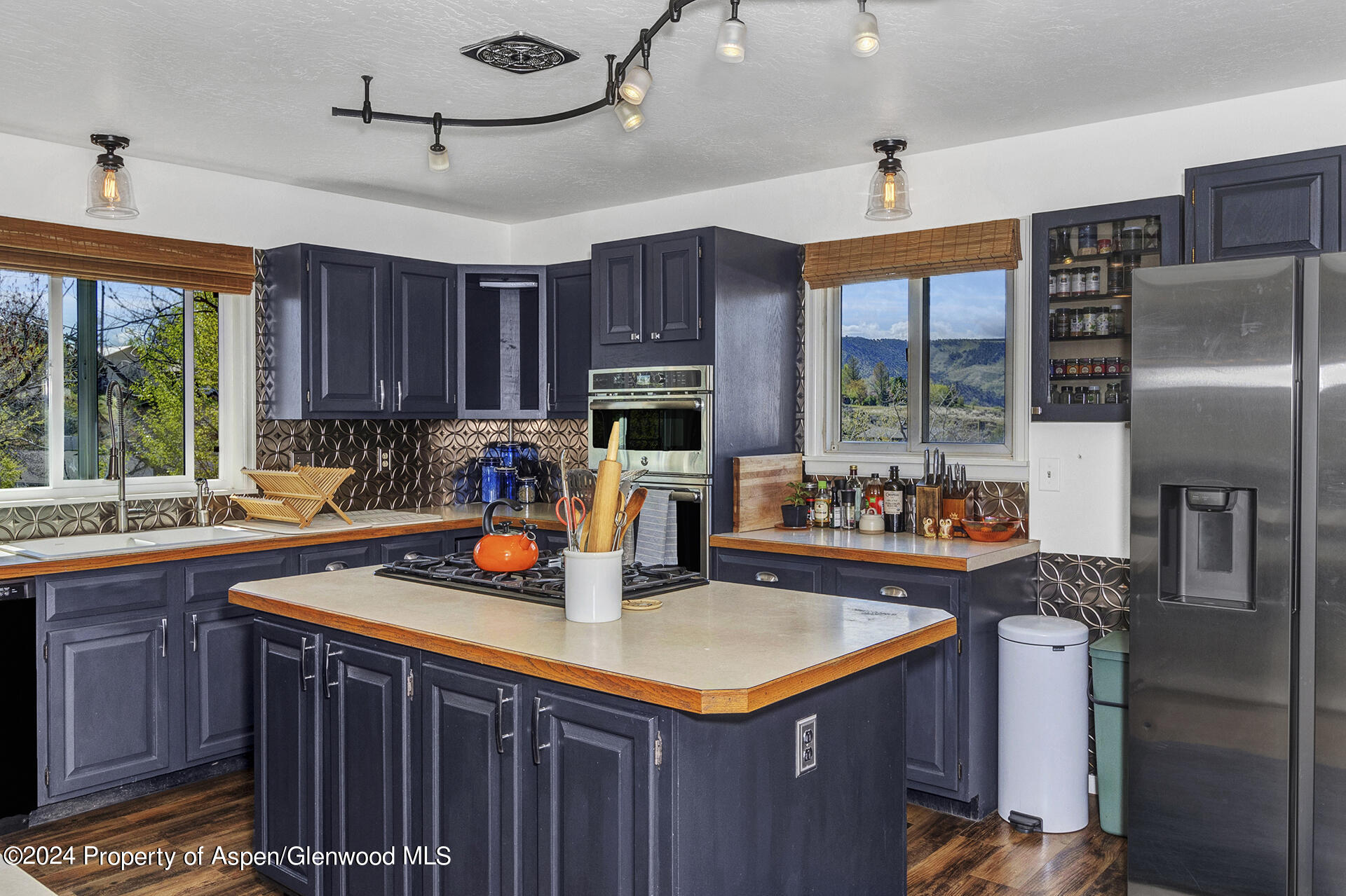 674 Mesa Court Rifle, CO 81650 - Photo 9 of 38 a kitchen with stainless steel appliances granite countertop a sink a stove and a refrigerator