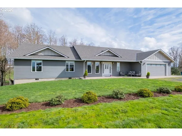 a view of a house with yard and a garden